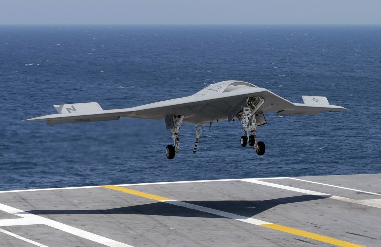 A X47-B Navy drone approaches the deck as it lands aboard the nuclear aircraft carrier USS George H. W. Bush off the Coast of Virginia Wednesday, July...
