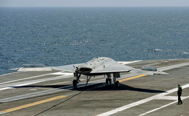 An X-47B pilot-less drone combat aircraft comes to a stop after landing on the deck of the USS George H.W. Bush aircraft carrier in the Atlantic Ocean...