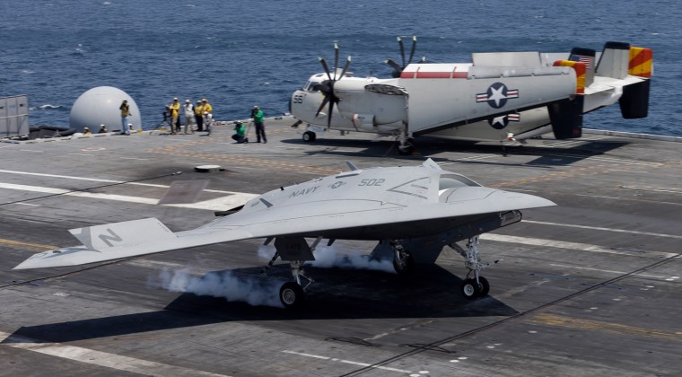 A X47-B Navy drone touches down as it lands aboard the nuclear aircraft carrier USS George H. W. Bush off the Coast of Virginia Wednesday, July 10, 20...