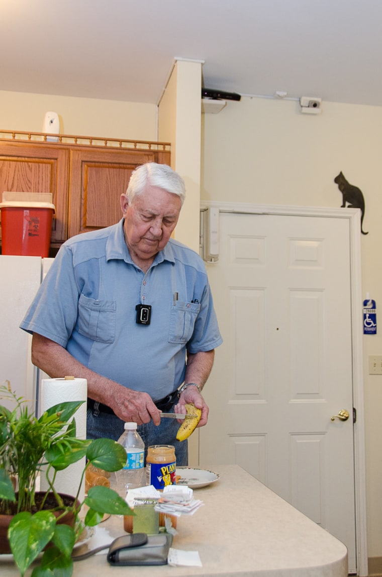 In this May 22, 2013 photo provided by the University of Missouri, Bob Harrison prepares a snack in his TigerPlace apartment in Columbia, Mo., as different sensors mounted near the ceiling record activity patterns. The sensor technology is unobtrusive and does not interfere with his everyday tasks. Researchers at the University of Missouri are studying high-tech monitoring systems that promise new safety nets for seniors living on their own.