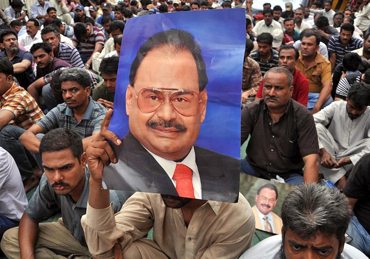 Supporters of the Mutahida Qaumi Movement hold a picture of the party leader Altaf Hussain in Karachi, Pakistan, on June 30.