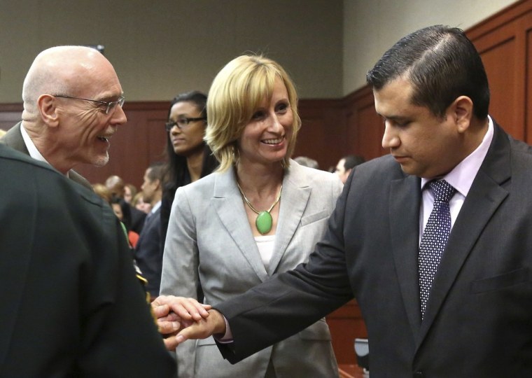 George Zimmerman, seen here being congratulated by his defense team after being found not guilty in the shooting death of Trayvon Martin, still faces federal scrutiny and a possible civil suit.