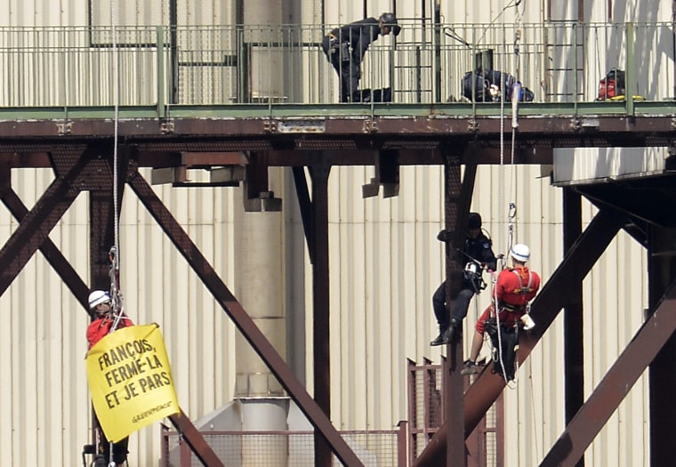 A Greenpeace campaigner is arrested Monday at a nuclear power plant in France.