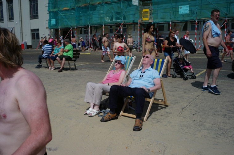 People sunbathe near a beach in Bournemouth, southern England, on July 14, 2013.