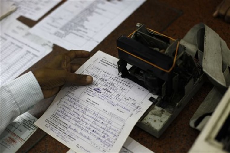 An Indian telegraph employee processes a telegram on the last day of the 163-year-old service at the central telegraph office in Mumbai, India, Sunday...