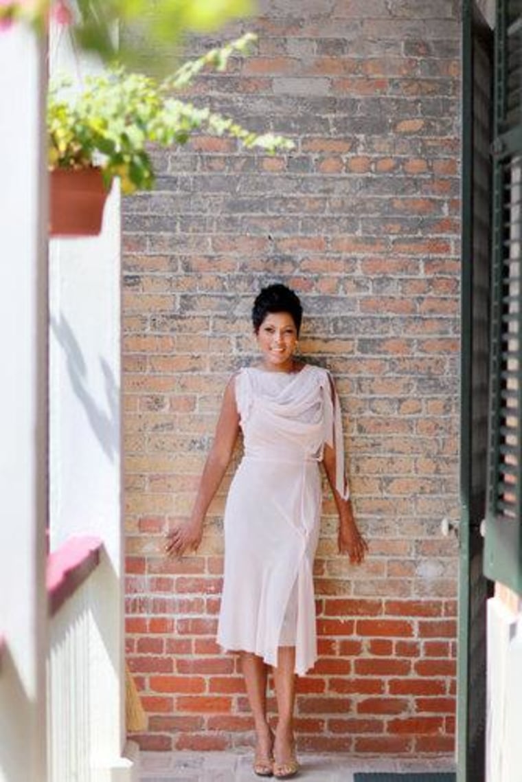 Tamron Hall at the Lanaux Mansion in New Orleans, in a Nina Ricci dress, Jimmy Choo shoes and Giles & Brother earrings.