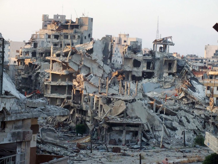 A general view shows damaged buildings on a deserted street in the besieged area of Homs on July 13, 2013.
