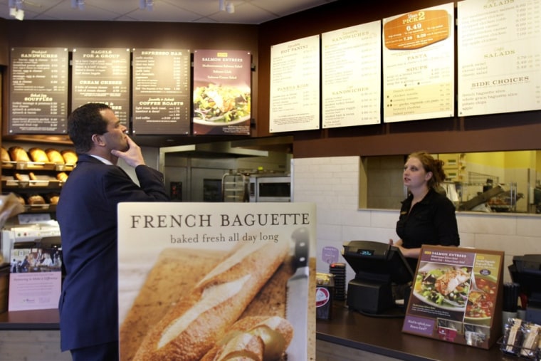 A customer reviews the sandwich board at the Panera store in Brookline, Mass. in this 2010 photo. Panera has withdrawn a pilot program that allowed cu...