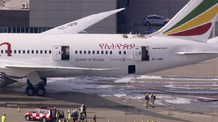 Emergency crew stands near the tail section of a Boeing 787 Dreamliner, operated by Ethiopian Airlines, which caught fire at Britain's Heathrow airpor...