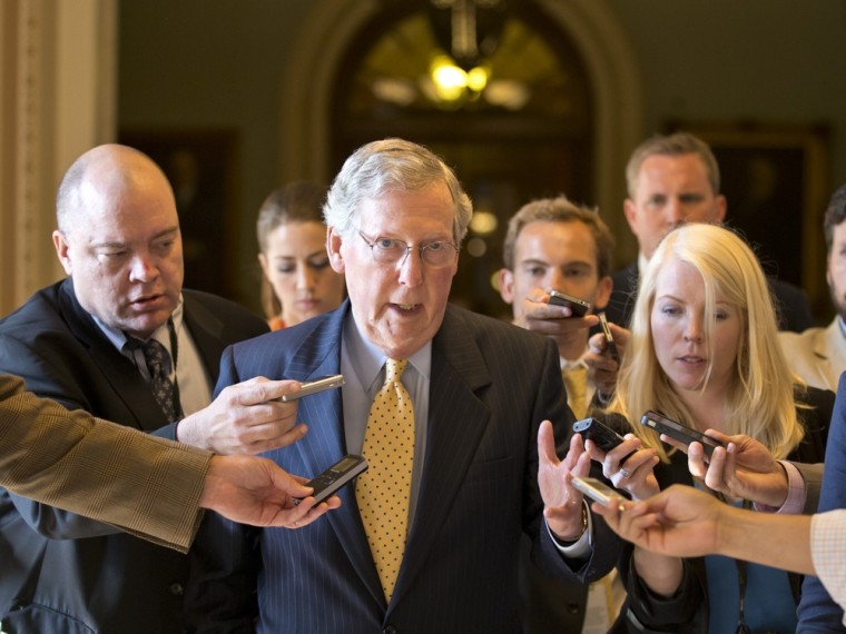 Senate Republican Leader Mitch McConnell of Kentucky is surrounded by reporters as he returns to his office after meeting with Senate Majority Leader Harry Reid, D-Nev., at the Capitol in Washington, Monday, July 15, 2013.