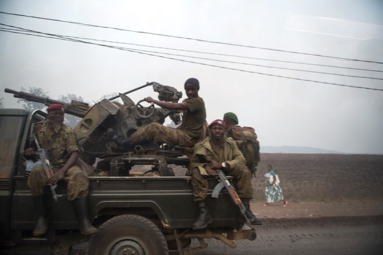 A group of Congolese army soldiers driving out of Goma on July 14, 2013, after exchanges of artillery and rocket-fire broke out between the Congolese army and M23 rebels.
