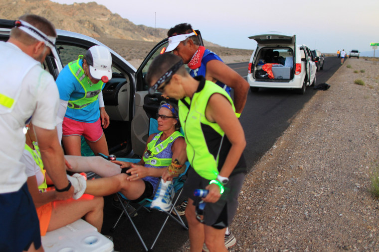 Lisa Smith-Blatchen of Driggs, Idaho receives first aid foot maintenance at Panamint Pass as night nears during the AdventurCORPS Badwater 135 ultra-marathon race on July 15, 2013 in Death Valley National Park, Calif.