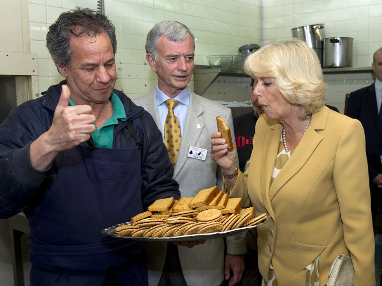 PARIS, FRANCE - MAY 27:  Camilla, Duchess of Cornwall tries a cake during a visit to EMMAUS Bougival on May 27, 2013 in Paris, France. The Duchess of ...