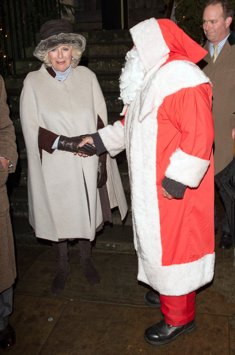 Image: Camilla meets Father Christmas and helps him switch on the Christmas lights on Dec. 7, 2012 in Tetbury, England.