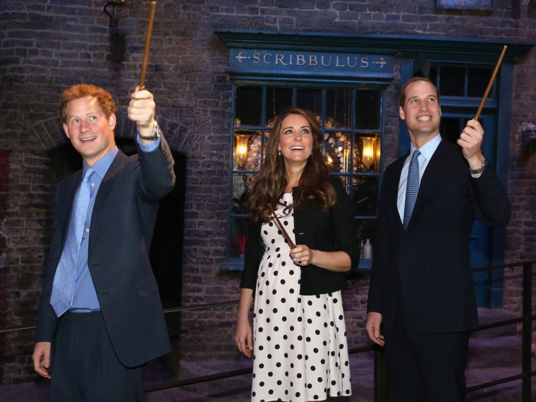 LONDON, ENGLAND - APRIL 26: Prince Harry, Catherine, Duchess of Cambridge and Prince William, Duke of Cambridge raise their wands on the set used to d...