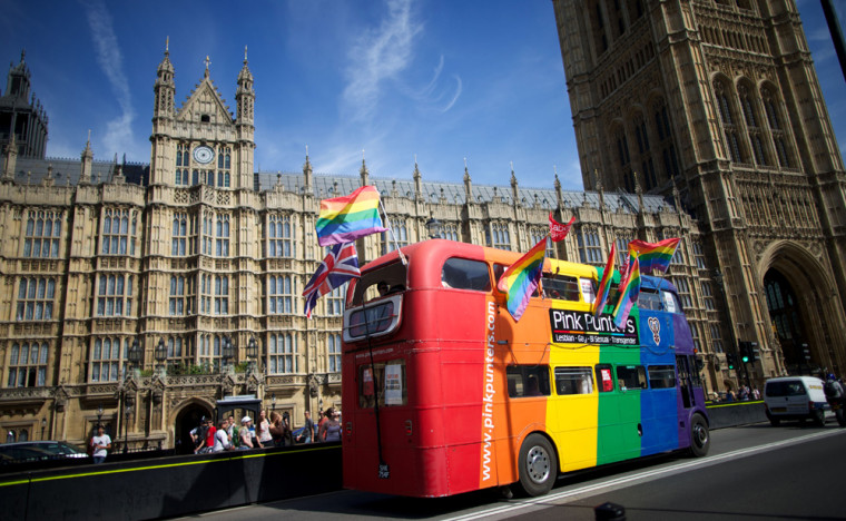 Gay rights campaigners drive a bus past Britain's Houses of Parliament on Monday.