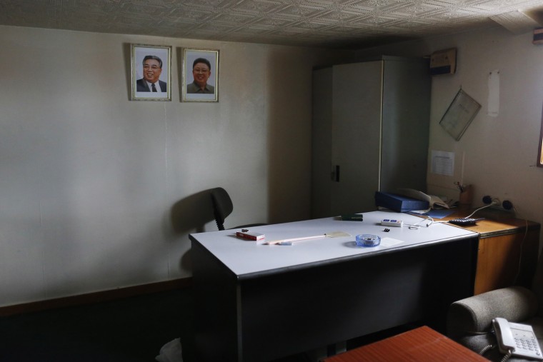 Portraits of former leader Kim Jong-il and former president Kim Il-sung are seen in one of the rooms inside a North Korean flagged ship