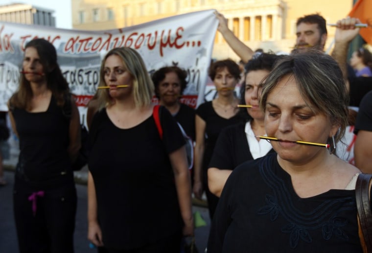 Municipal employees demonstrate in front of the parliament building in Athens on July 17, 2013.