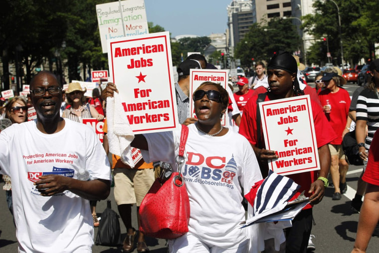 Demonstrators march against amnesty for illegal aliens, during a rally against the immigration reform bill in Pennsylvania Avenue in Washington July 1...