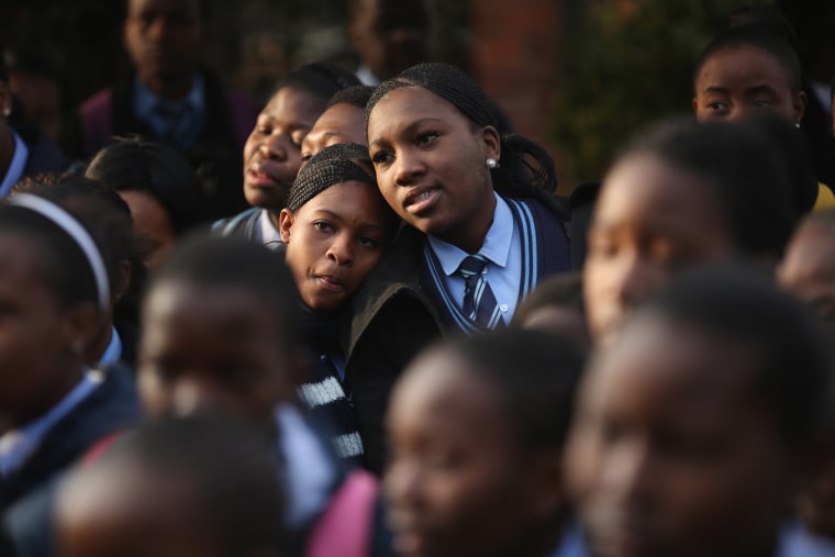Schoolchildren pray for Mandela after singing