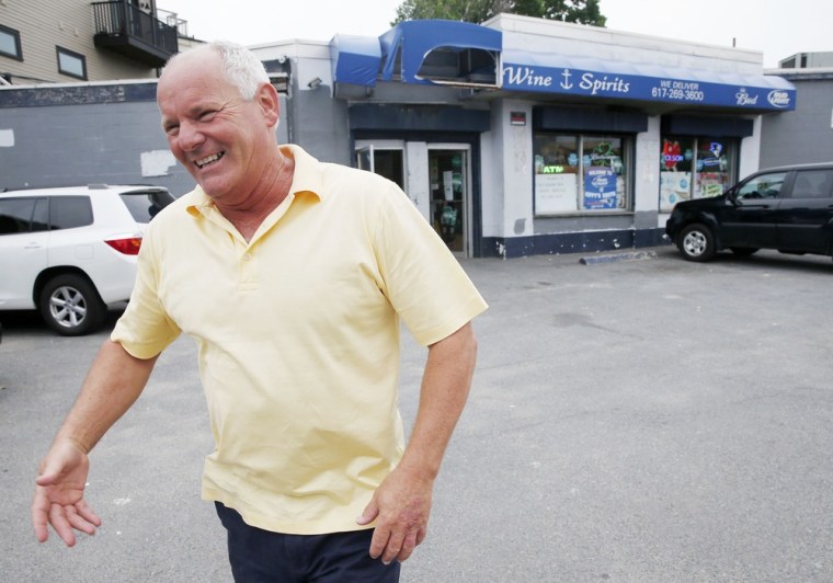 Stephen Rakes smiles after greeting an acquaintance outside the liquor store he once owned in the South Boston neighborhood of Boston. Rakes was found dead Wednesday in a Boston suburb.