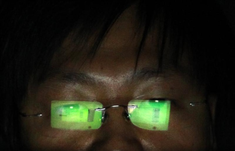A hacker, who requests not to have his name revealed, works on his laptop in his office in Taipei July 10, 2013. REUTERS/Pichi Chuang
