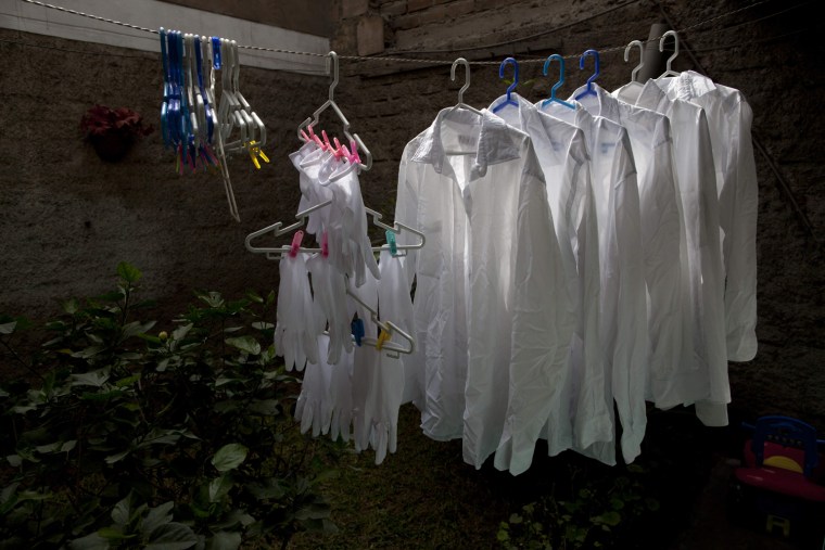 Freshly-washed white shirts and gloves dry in the garden of the leader of a group of pallbearers in Lima on June 6, 2013. Blacks are all but absent from Peru's business and political elite and although slavery was abolished in 1854 only about 2 percent of Peru's blacks go to college and census-takers don't even count them.
