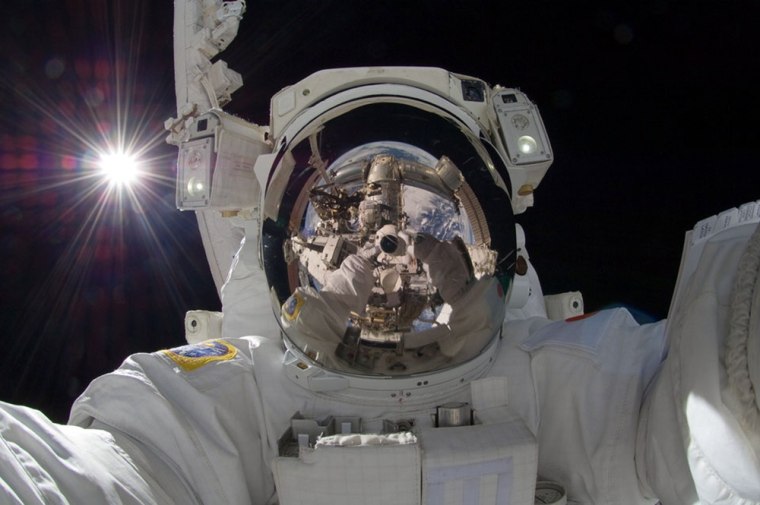 This Sept. 18, 2012 photo released by NASA shows international space station astronaut Aki Hoshide taking a self-portrait while in space. The practice...