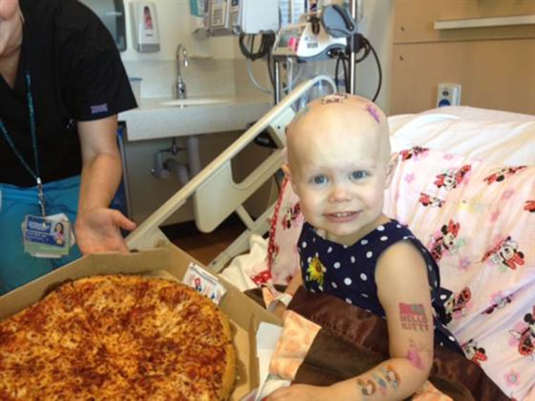 Two-year-old Hazel Hammersley with one of the pizza deliveries made thanks to Reddit users.