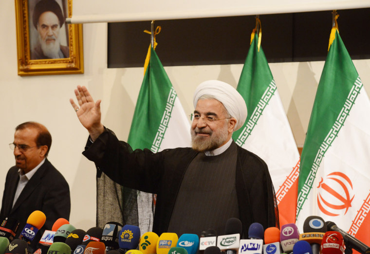 Iran's president elect Hassan Rowhani waves during his first press conference on June 17.