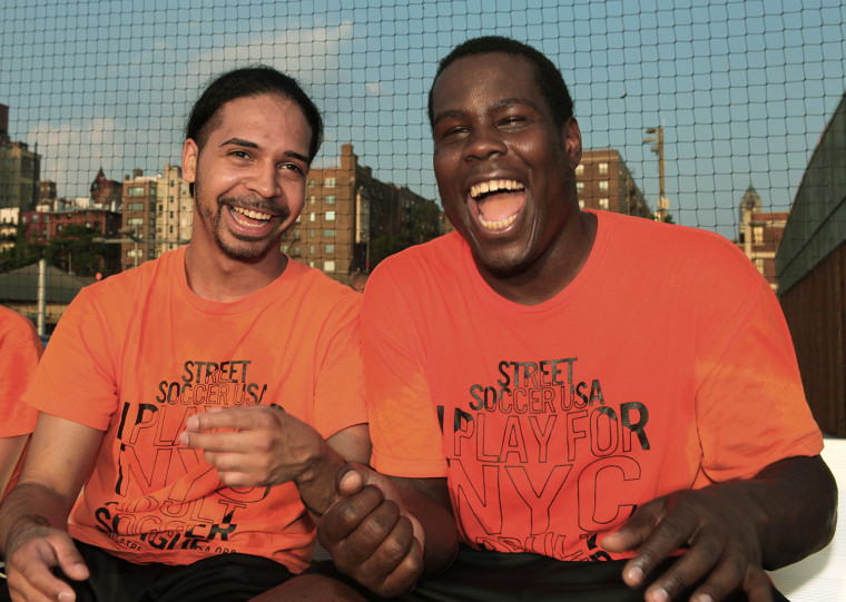 Dennis Diaz, left, and Brandon Chapman laugh it up on the sidelines during a break in a Street Soccer game in Brooklyn Bridge Park on July 17 in New York City.