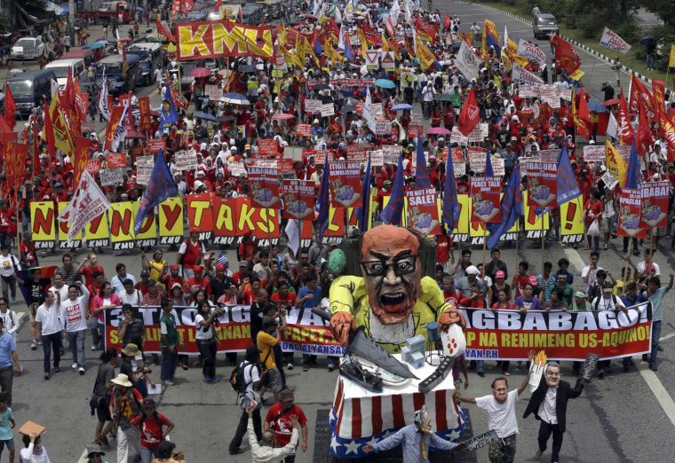 Protesters march towards the House of Representatives where President Benigno Aquino III is set to deliver his fourth State-of-the-Nation Address, July 22, 2013.