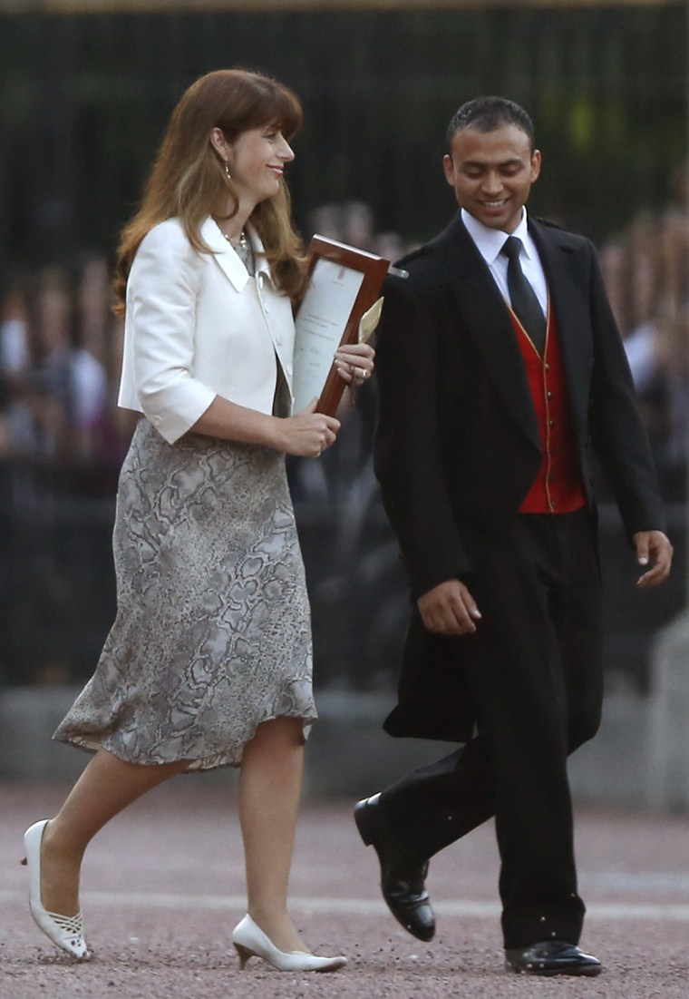 The Queen's Press Secretary Ailsa Anderson with Badar Azim, a footman, carry out the official baby announcement.