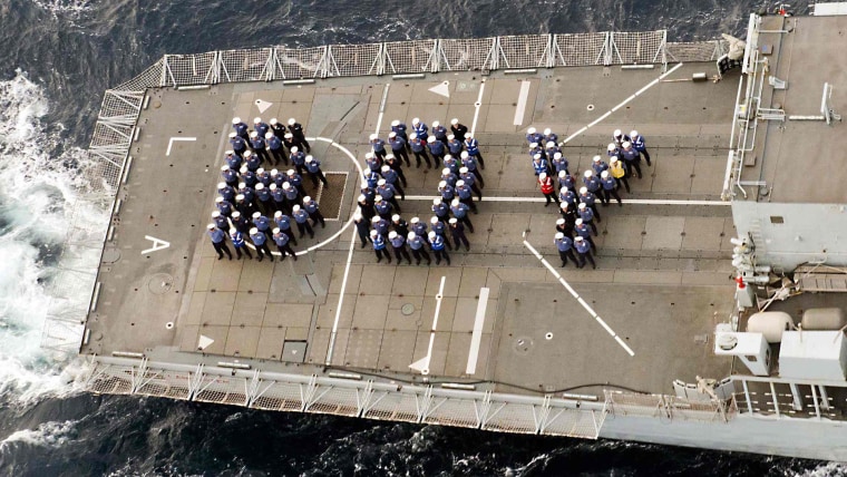 The ship's company of the Royal Navy frigate HMS Lancaster forms the word \"BOY\" on the aft deck to mark the birth of Britain's new prince while on pat...
