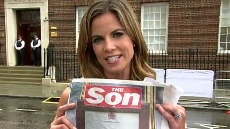 Natalie Morales holds up the U.K. newspaper The Sun, which changed its header in honor of the baby.