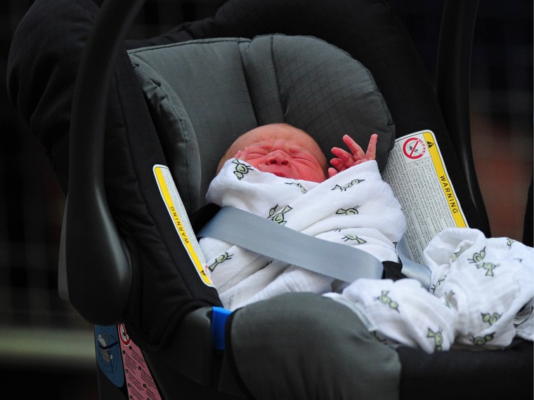 Image: Prince William and Duchess Kate's newborn baby boy is seen in a car seat outside the Lindo Wing of St Mary's Hospital in London.