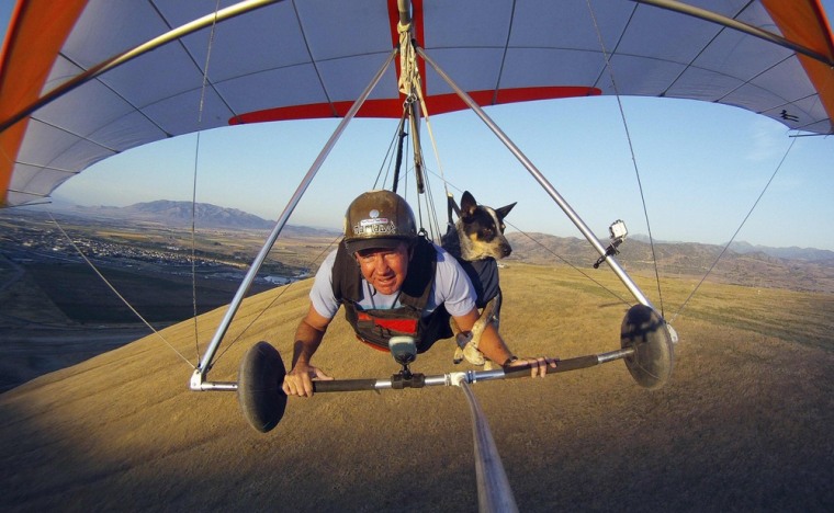 Dan McManus and his service dog Shadow hang glide together outside Salt Lake City, Utah, on July 22. McManus suffers from anxiety and Shadow's presence and companionship help him to manage the symptoms. The two have been flying together for about nine years with a specially-made harness for Shadow.