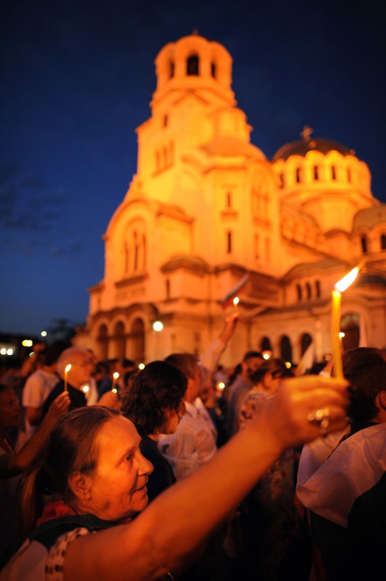 A woman holds a candle during an anti-government protest in Sofia on July 23.