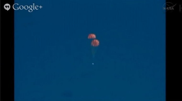 The Orion capsule falls to Earth with parachutes deployed at Yuma Proving Ground, Arizona, on July 24, 2013.