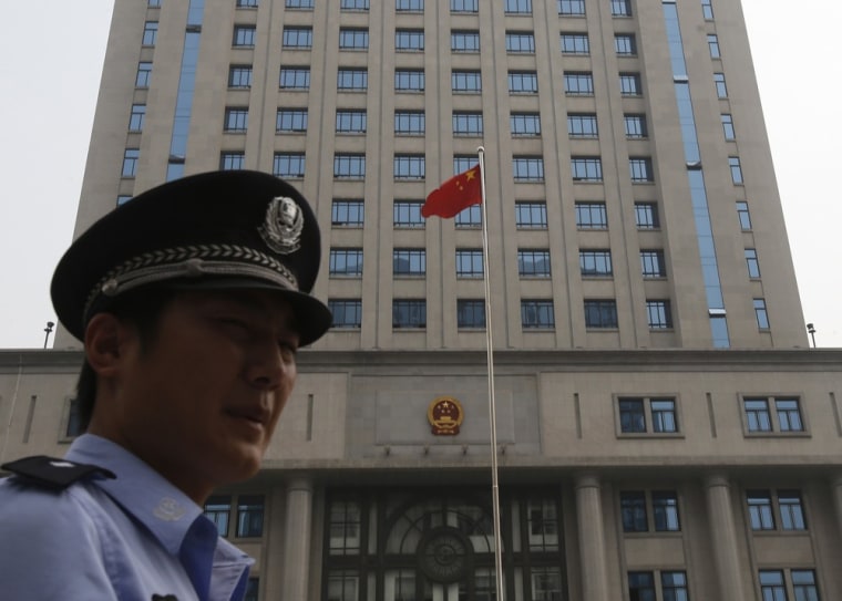 A policeman stand guard Thursday in front of the Jinan Municipality People's Intermediate Courthouse buidling where the Bo Xilai trial is likely to be held.