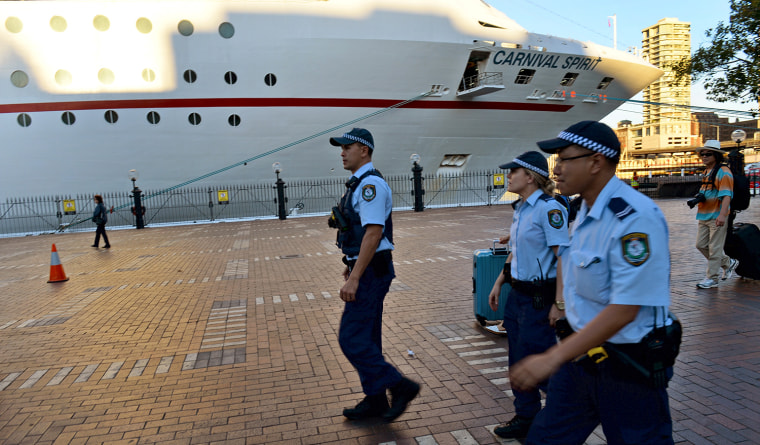 Police arrive at Sydney's Circular Quay after two passengers fell overboard from the cuise ship Carnival Spirit as it returned to Sydney from a Pacific cruise, on May 9, 2013. A search was underway off Australia for the couple in shark-infested waters and after reviewing security footage on the ship, police said they believe the pair fell overboard just before 9pm on Wednesday (1100 GMT Wednesday) around 65 nautical miles off the coast, north of Sydney. AFP PHOTO/William WESTWILLIAM WEST/AFP/Getty Images