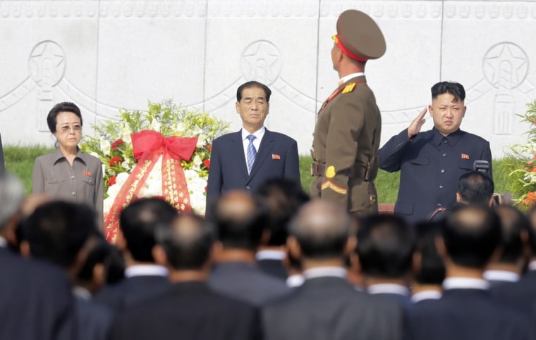 North Korean leader Kim Jong Un (right) salutes during a ceremony in Pyongyang on Thursday.