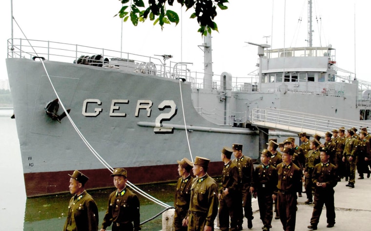 North Korean soldiers look at the USS Pueblo near the Taedonggang river in Pyongyang in 2006.