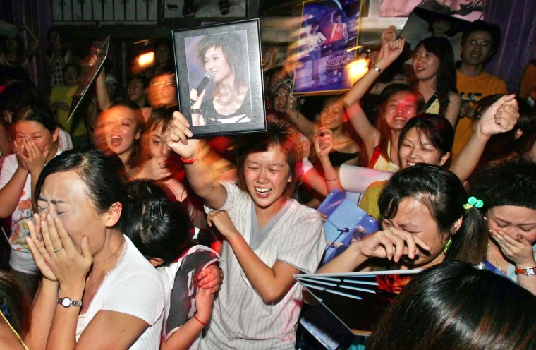 Fans celebrate after Li Yuchun was declared winner of the 2005 Super Girl contest finals, in Shanghai.