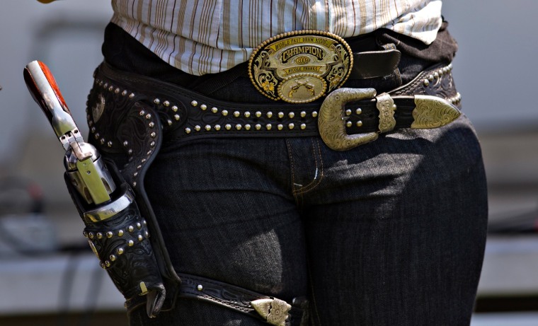 Nicole Franks of Aldergrove wears a World Championship belt buckle along with her gun during the Canadian Open Fast Draw Championships in Aldergrove, British Columbia July 20, 2013. Franks has won multiple World Championships since 2000.