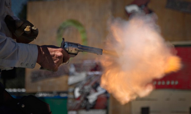 Brian Colwell of Loveland, Colo., fires his single action western style revolver during a competition at the Canadian Open Fast Draw Championships in Aldergrove, British Columbia July 21, 2013.