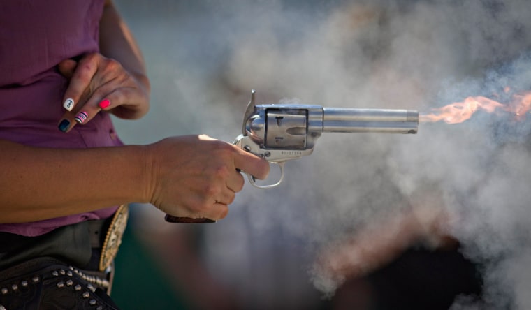 Nicole Franks of Aldergrove fires her single action revolver while competing in the Canadian Open Fast Draw Championships in Aldergrove, British Columbia July 21, 2013.