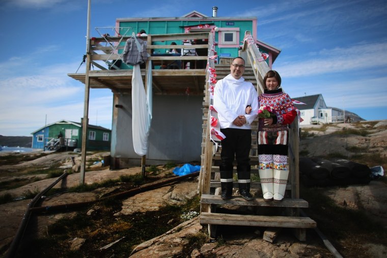 Ottilie Olsen and Adam Olsen pose for a picture on July 20, in Qeqertaq, Greenland. Greenlanders are learning to adapt to the changing climate and go on with their lives.