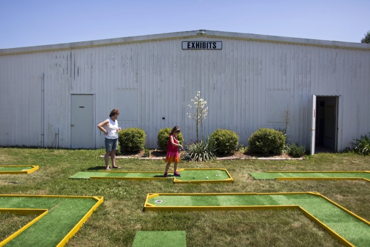 Joyce Novak watches her granddaughter Elise Wing negotiate a makeshift putt-putt course at Marshall County's Central Iowa Fair in Marshalltown on July 12.