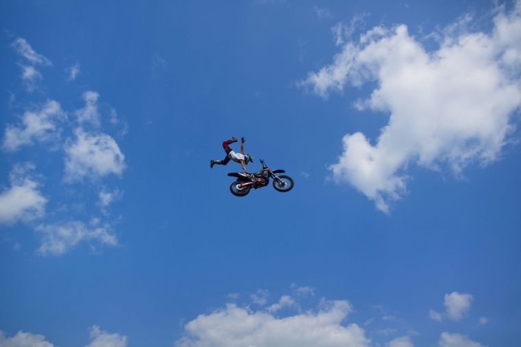 Stunt rider Jake Goodyear flies through the air during a motorcycle daredevil show at the Delaware County Fair in Manchester, Iowa, on July 11, 2013.